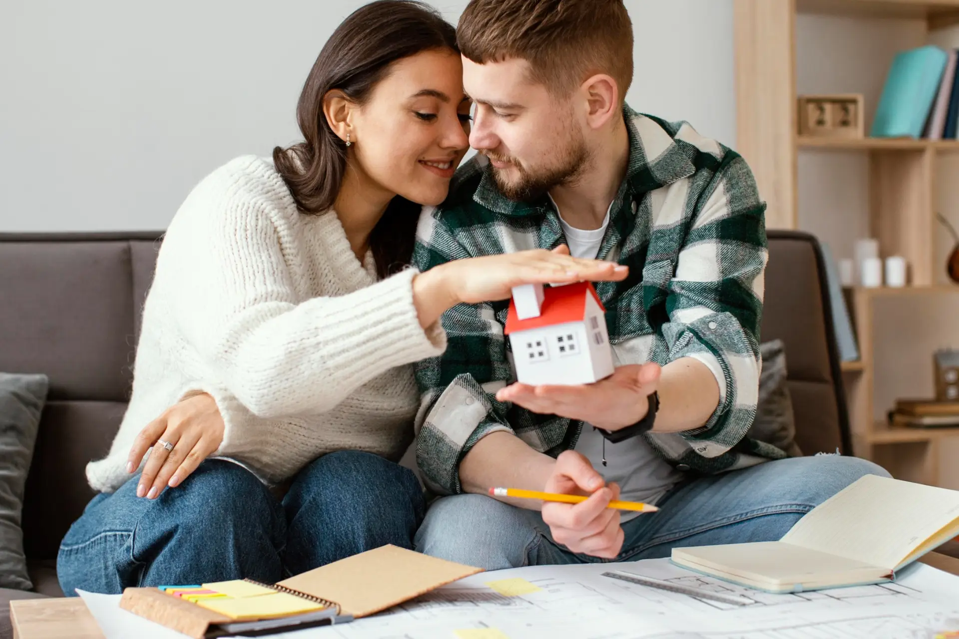 Medium shot couple holding small house